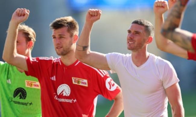 Robin Gosens celebrates in front of the away fans at full-time in Darmstadt