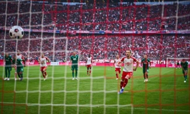 Harry Kane scores from the penalty spot on his home debut for Bayern Munich